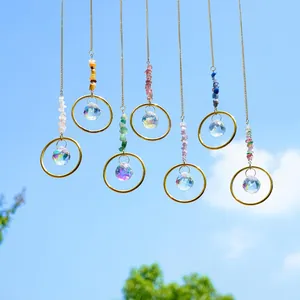 7-piece crystal suncatcher set with natural stones and prisms hanging against blue sky
