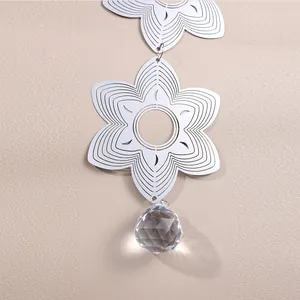 Detail of 3D stainless steel wind spinner with geometric mandala and crystal drop