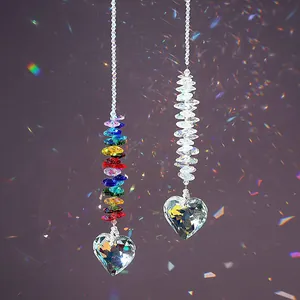 Rainbow and clear heart crystal suncatchers creating colorful light reflections on wall