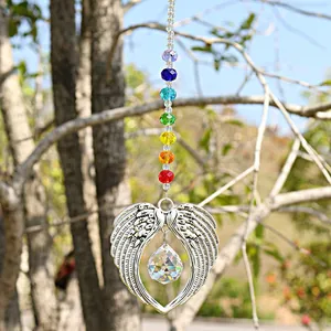 Macro detail of angel wing suncatcher with rainbow beads and multifaceted crystal ball