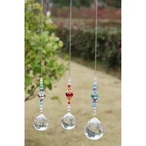 Detail of three crystal suncatchers with faceted prism balls on silver chains