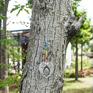 Macro detail of crystal suncatcher with angel wings and colorful rainbow beads
