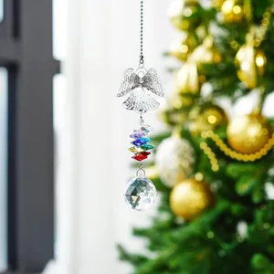 Close-up of crystal angel suncatcher with rainbow beads hanging on a Christmas tree