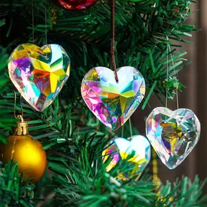 Close-up of iridescent heart crystal pendants hanging on a Christmas tree branch