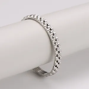 Detailed view of silver gear-textured metal bracelet with industrial geometric facets