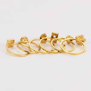 Detailed macro view of 6-piece gold stainless steel ring set with diverse geometric shapes