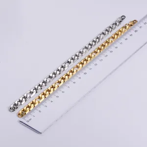 Detailed view of gold and silver figaro bracelets measured with a metric ruler
