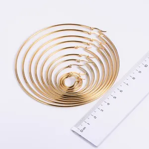 Multiple sizes of golden hoop earrings ranging from 15mm to 105mm with a scale ruler