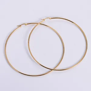 Close-up of high-polish gold plated stainless steel hoop earrings with secure hinge clasp