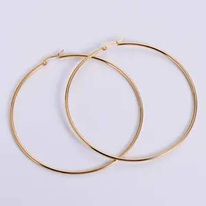 Macro view of large 18k gold plated stainless steel hoop earrings with polished finish