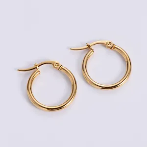 Detail view of large gold hoop earrings with polished finish and secure clicker clasp