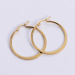 Detail of high-polish gold flat hoop earrings with latch-back closure on lilac background