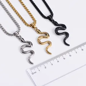 Detail of snake pendants in silver, gold, and black finishes with scale textures