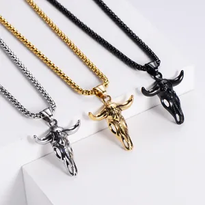 Ox skull pendant necklaces in silver, gold, and black finish on geometric stands
