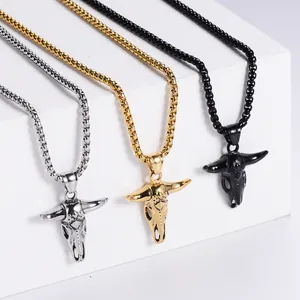 Detailed close-up of punk bull skull pendants in silver, gold, and black finishes