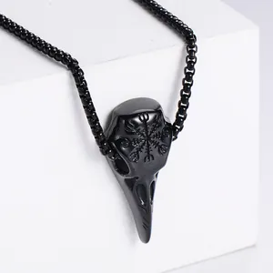 Detail shot of black stainless steel raven skull pendant with Viking compass engraving