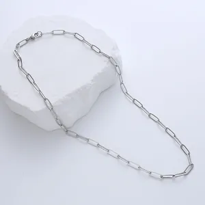 Polished stainless steel paperclip chain necklace with lobster clasp on white stone
