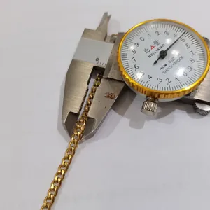 Close-up measurement of gold stainless steel curb chain width with digital caliper