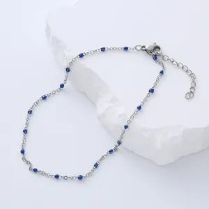 Detail of silver chain anklet with blue glazed beads, lobster clasp and extension chain