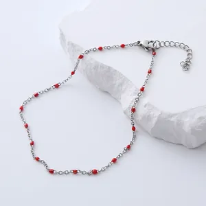 Detail of silver chain anklet with red droplet beads, lobster clasp and extension