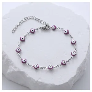 Detail of silver stainless steel chain bracelet with purple devil eye enamel charms