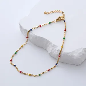 Bohemian gold stainless steel anklet with colorful beads on a white stone background