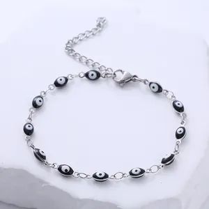 Bracelet en acier inoxydable argenté avec yeux bleus émaillés noirs et fermoir mousqueton