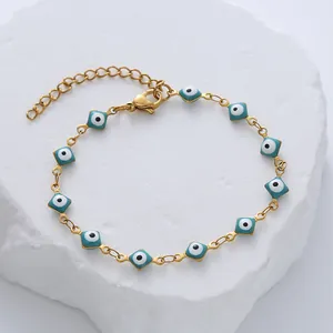 Gold plated titanium steel evil eye bracelet with blue diamond-shaped enamel charms