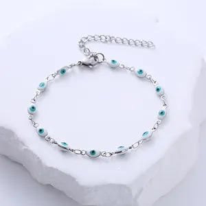 Détail d'un bracelet mauvais œil en acier argenté avec breloques en émail bleu sur pierre