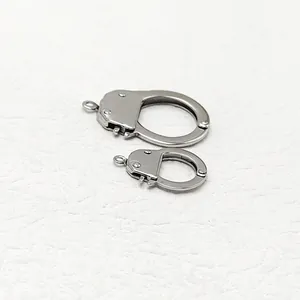 Macro view of silver stainless steel handcuff pendants for DIY jewelry crafting