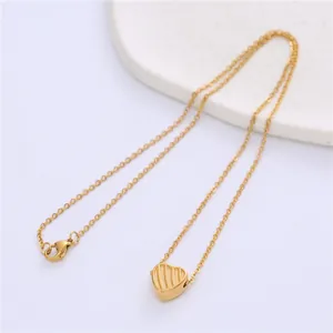Gold stainless steel heart pendant necklace with vertical textured stripes on elegant chain