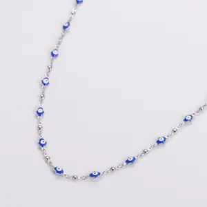 Polished stainless steel necklace with blue and white evil eye beads on white background