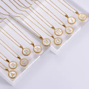 Close-up of 18k gold plated necklaces with white shell alphabet letter pendants
