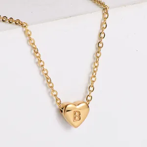Close-up of a gold 18K plated heart pendant necklace with embossed letter B detail