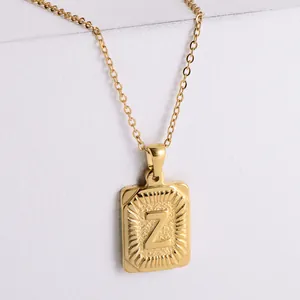 Detailed macro view of 18k gold plated rectangle pendant with embossed letter Z