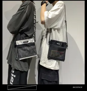 Detail of minimalist nylon mesh shoulder bags in black and white with adjustable straps