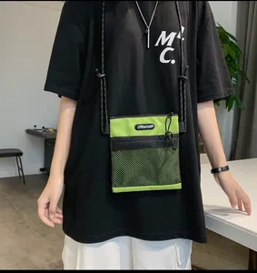 Detail shot of neon green nylon crossbody bag with black mesh pocket and offbetter logo