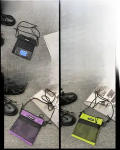 Mini nylon mesh crossbody bag detail with long strap and brand label on front