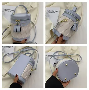 Detailed views of light blue and cream patchwork bucket bag with wavy quilting and gold studs