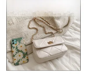 White quilted chain crossbody bag size comparison with a small daisy pattern phone case