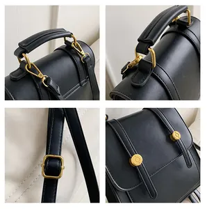Close-up of black leather bag with vintage gold metal hardware and matte texture