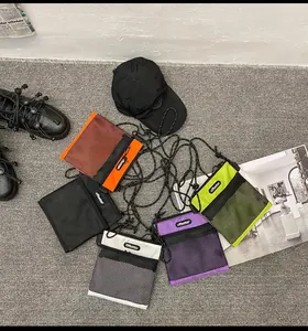 Detailed flat lay of nylon mini crossbody bags in five colors with mesh front pocket