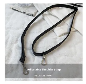 Detail of adjustable black leather shoulder strap with silver metal lobster clasps