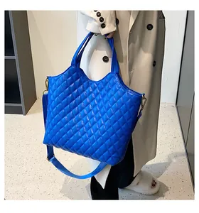 Blue quilted tote bag with golden hardware shown as a stylish large handbag