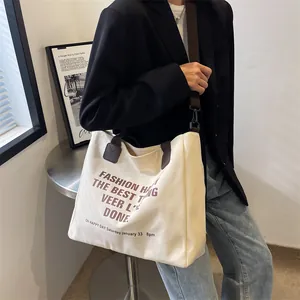 Minimalistische gebroken witte canvas shopper met bruine handvatten en modeprint