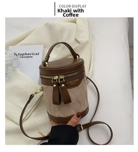 Top view of a khaki and coffee contrast bucket bag with quilted patterns and metal zippers