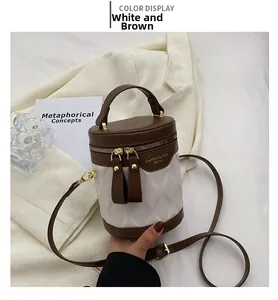 Detail of white quilted leather bucket bag with coffee trim and gold-tone hardware