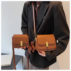 Detailed comparison of two sizes of brown faux leather shoulder bags with gold hardware
