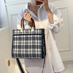 Classic houndstooth plaid tote bag with tortoiseshell handles and striped wide strap
