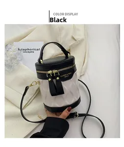Detailed top view of a black and beige bucket bag with gold zipper and leather handle